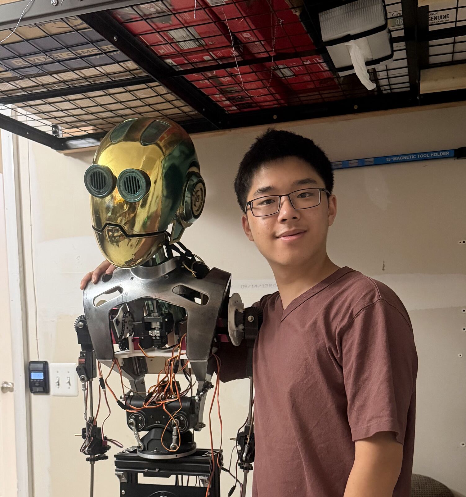 Qichen standing next to The Professor robot